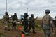 U.S. Air Force Airmen carry a victim from a simulated chemical attack to a decontamination tent during Exercise Bushwhacker 19-08 at Libby Army Airfield, Arizona, Nov. 6, 2019.