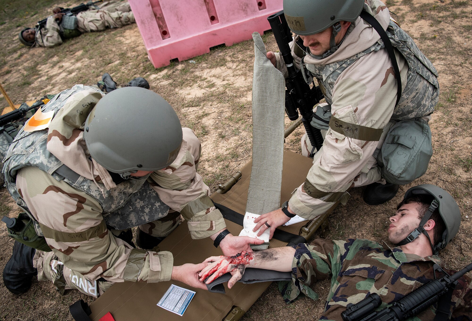 Airmen provide care to a victim’s fractured arm during a chemical, biological, radiological, nuclear and explosive exercise at Eglin Air Force Base, Florida, Nov. 7. The Air Force Materiel Command evaluation exercised the Airmen’s ability to meet wartime and contingency taskings of employing and sustaining the force and the ability to survive and operate. (U.S. Air Force photo by Samuel King Jr.)
