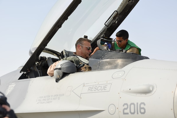 A U.S. Air Force crew chief assists U.S. Air Force Lt. Gen. Joseph Guastella, commander of U.S. Air Forces Central Command, before his flight in an F-16 Fighting Falcon at Al Udeid Air Base, Qatar Nov. 4, 2019.