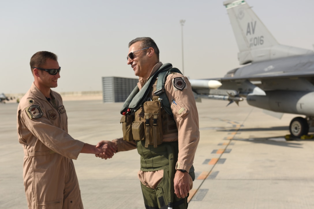 U.S. Air Force Lt. Col. Beau Diers, commander of the 555th Fighter Squadron, shakes hands with USAF Lt. Gen. Joseph Guastella, commander of U.S. Air Forces Central Command, before the general’s flight in an F-16 Fighting Falcon at Al Udeid Air Base, Qatar Nov. 4, 2019.