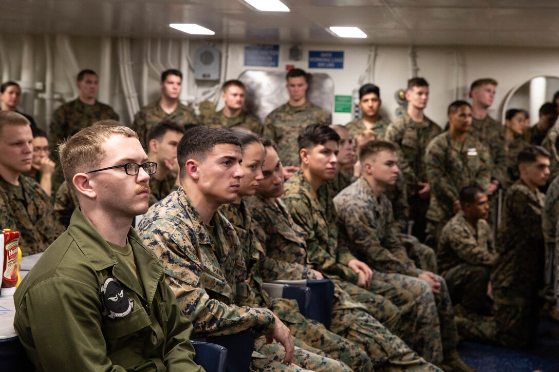 191110-M-EC058-1085 PACIFIC OCEAN (Nov. 10, 2019) U.S. Marines and Sailors with the 11th Marine Expeditionary Unit (MEU), observe a speaker during a 244th Marine Corps birthday celebration aboard the amphibious assault ship USS Boxer (LHD 4). The Marines and Sailors of the 11th MEU are conducting routine operations as part of the Boxer Amphibious Ready Group in the eastern Pacific Ocean. (U.S. Marine Corps photo by Cpl. Dalton S. Swanbeck)