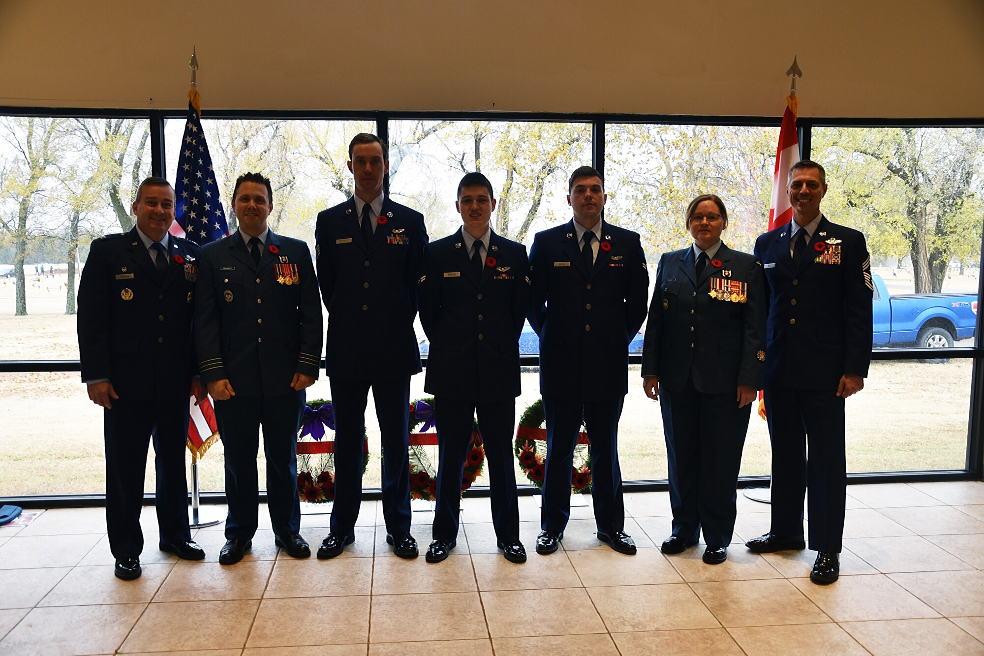 Lt. Col Shawn Guilbault, commander of the Canadian Detachment, Col. Alain Poisson, commander of the 552nd Air Control Wing, and Airmen of the 552nd ACW stand united as Canada honors their Remembrance Day.  Remembrance Day is a Canadian holiday held on Nov. 11 and marks the end of hostilities in World War I and serves as an opportunity to recall those who have served since.