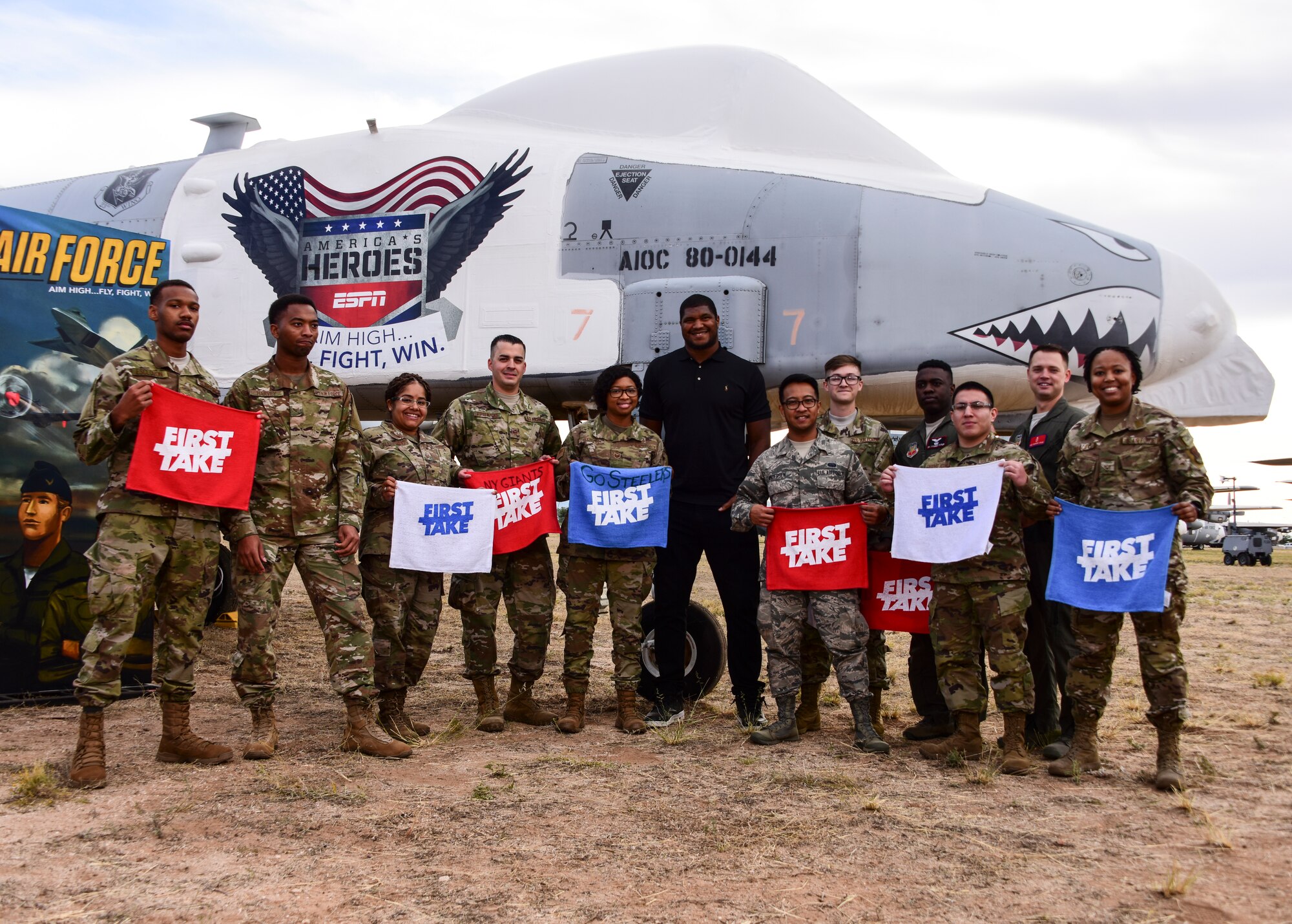 A photo of airmen cheering in the audience during an airing of ESPN's "First Take".