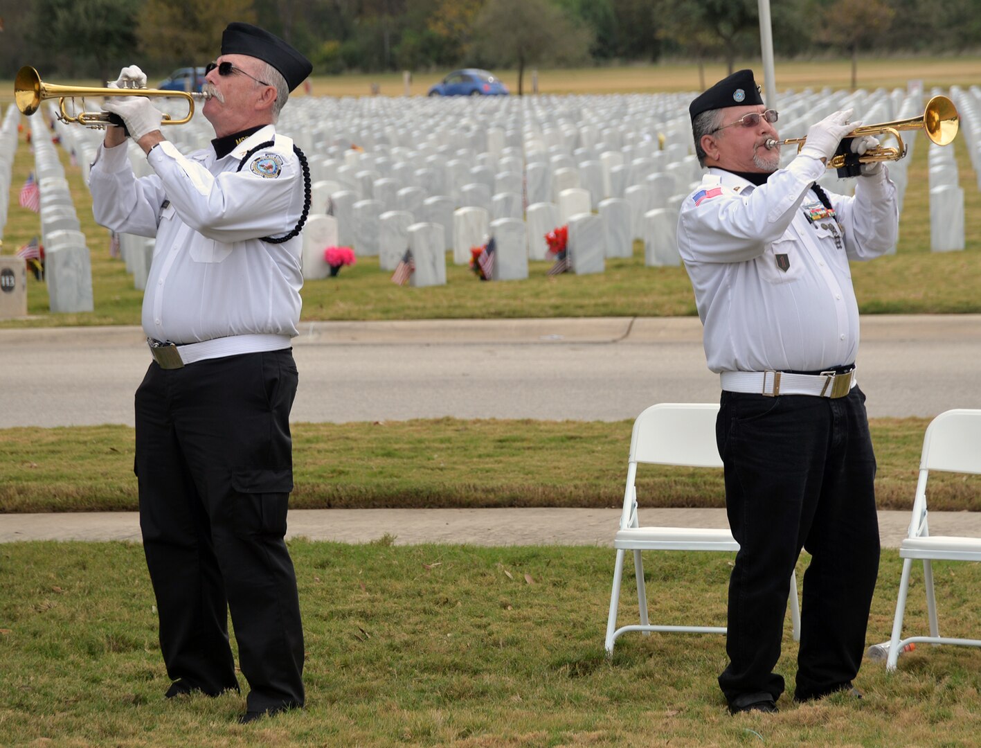 Robert Kinkade (left) and Robert Ramirez (right) from the Fort Sam Houston Memorial Services Detachment  render "Taps" at the conclusion of the Fort Sam Houston National Cemetery Veterans Day Ceremony Nov. 11.