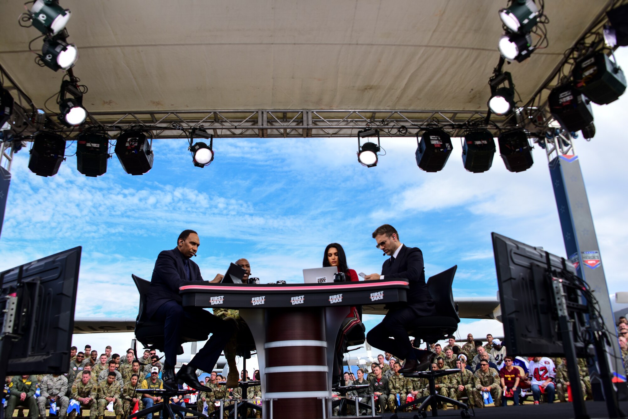 A photo of airmen cheering in the audience during an airing of ESPN's "First Take".