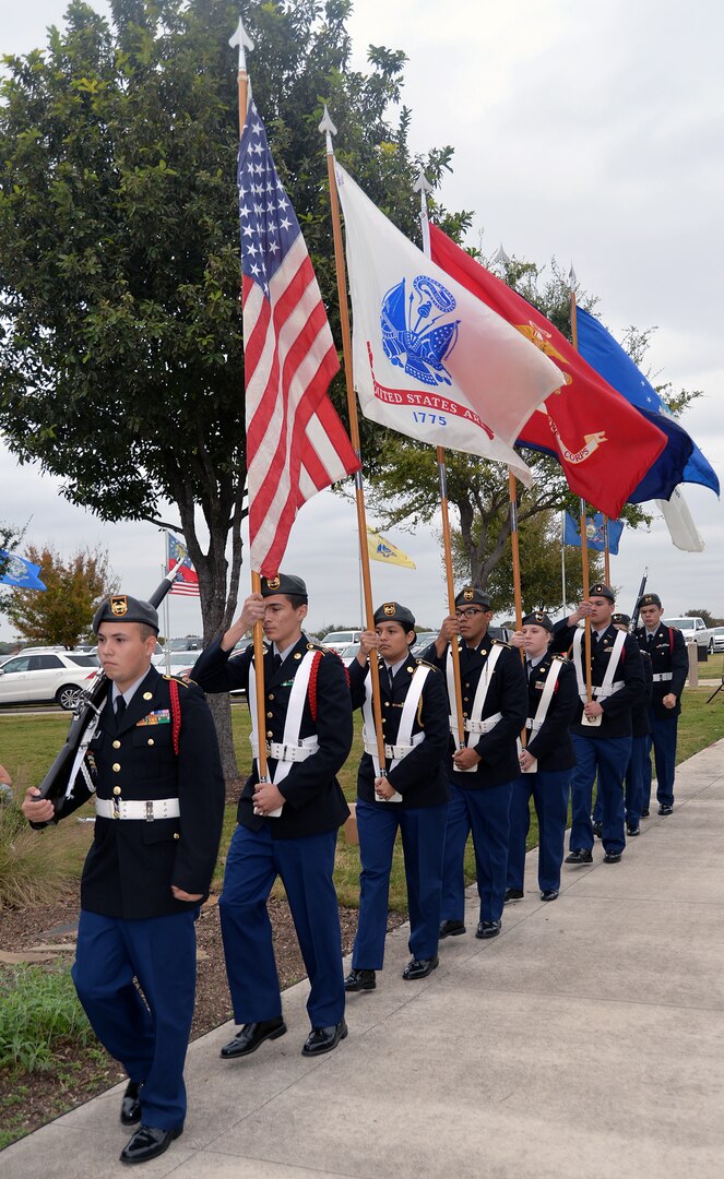 Members of the Douglas McArthur High School Army Junior ROTC march in the colors during the Fort Sam Houston National Cemetery Veterans Day Ceremony Nov. 11.