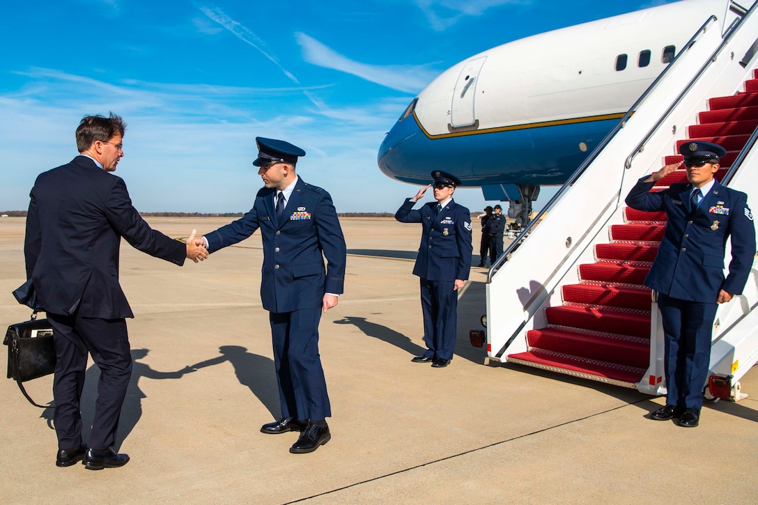 Defense Secretary Dr. Mark T. Esper shakes hands with a service member.