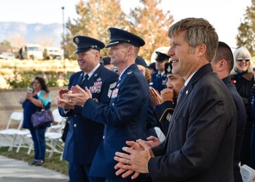 Albuquerque Mayor Tim Keller (right), U.S. Air Force Col. David S. Miller (center), 377th Air Base Wing commander and U.S. Air Force Chief Master Sgt. Robert Stamper (left), 377th ABW command chief, applaud new recruits at the Albuquerque Veterans Day ceremony at the New Mexico Veterans Memorial Nov. 11, 2019.  The public event was attended by veterans and service members from each branch of military with their families, Air Force ROTC, Junior ROTC as well as state and local government leaders. (U.S. Air Force photo by Airman 1st Class Austin J. Prisbrey)