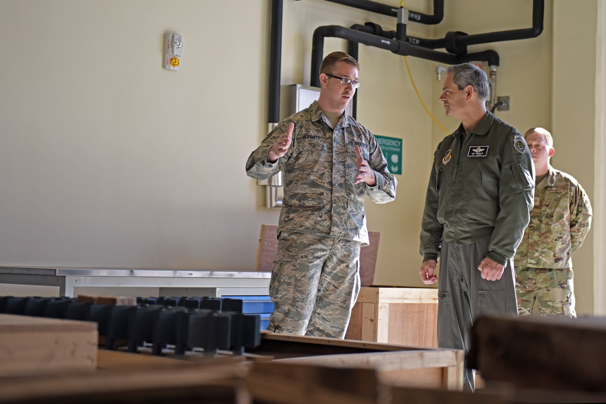 U.S. Air Force Staff Sgt. Thomas Herriott, 8th Maintenance Squadron munitions specialist, talks with Lt. Gen. Ken Wilsbach, 7th Air Force commander, about innovative solutions to munitions storage and transportation during a base visit to Kunsan Air Base, Republic of Korea, Nov. 8, 2019. During his visit, Wilsbach also had the opportunity to speak with first-term Airmen, tour the 8th Security Forces Squadron Military Working Dog kennels. (U.S. Air Force photo by Staff Sgt. Mackenzie Mendez)