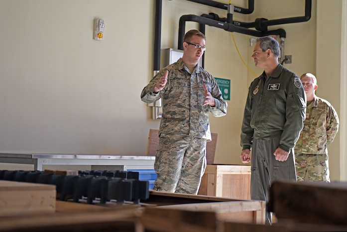 U.S. Air Force Staff Sgt. Thomas Herriott, 8th Maintenance Squadron munitions specialist, talks with Lt. Gen. Ken Wilsbach, 7th Air Force commander, about innovative solutions to munitions storage and transportation during a base visit to Kunsan Air Base, Republic of Korea, Nov. 8, 2019. During his visit, Wilsbach also had the opportunity to speak with first-term Airmen, tour the 8th Security Forces Squadron Military Working Dog kennels. (U.S. Air Force photo by Staff Sgt. Mackenzie Mendez)