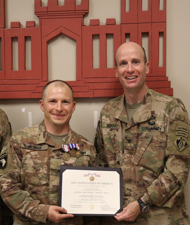 MAJ Christopher George is presented a Defense Meritorious Service Medal from USACE Afghanistan District Commander, Chris Becking, for leading the New York-based FEST-A team while deployed to Afghanistan.
