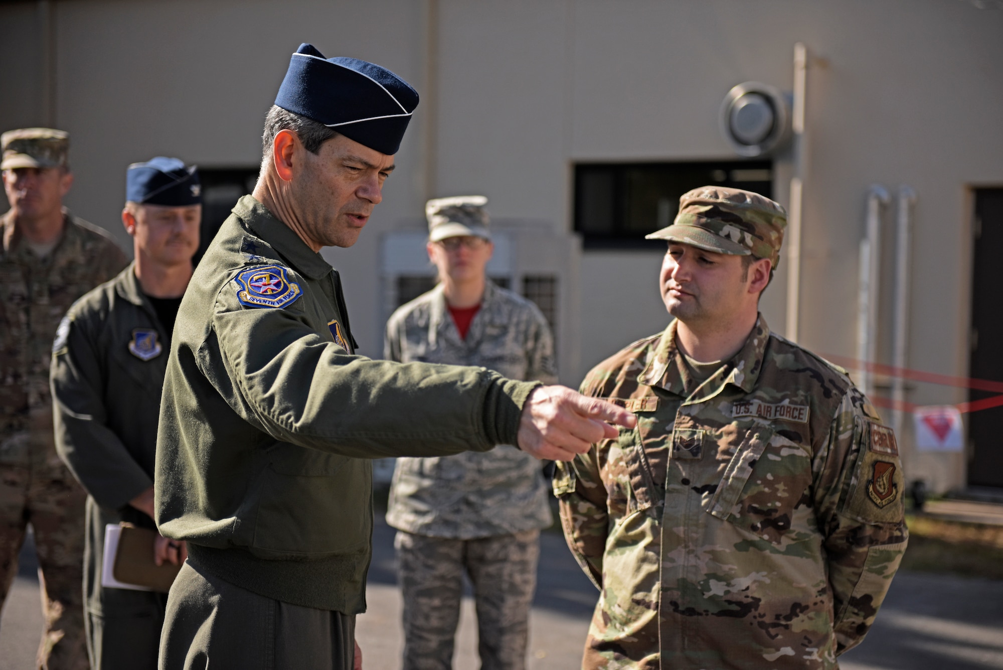 U.S. Air Force Lt. Gen. Ken Wilsbach, 7th Air Force commander, speaks with Staff Sgt. Christopher Hoppler, 8th Civil Engineer Squadron craftsman, during a base visit at Kunsan Air Base, Republic of Korea, Nov. 7, 2019. Wilsbach learned about how the 8th Civil Engineer Squadron is paving the way for future Airmen to operate and accomplish their mission in safer and healthier environments. (U.S. Air Force photo by Staff Sgt. Mackenzie Mendez)