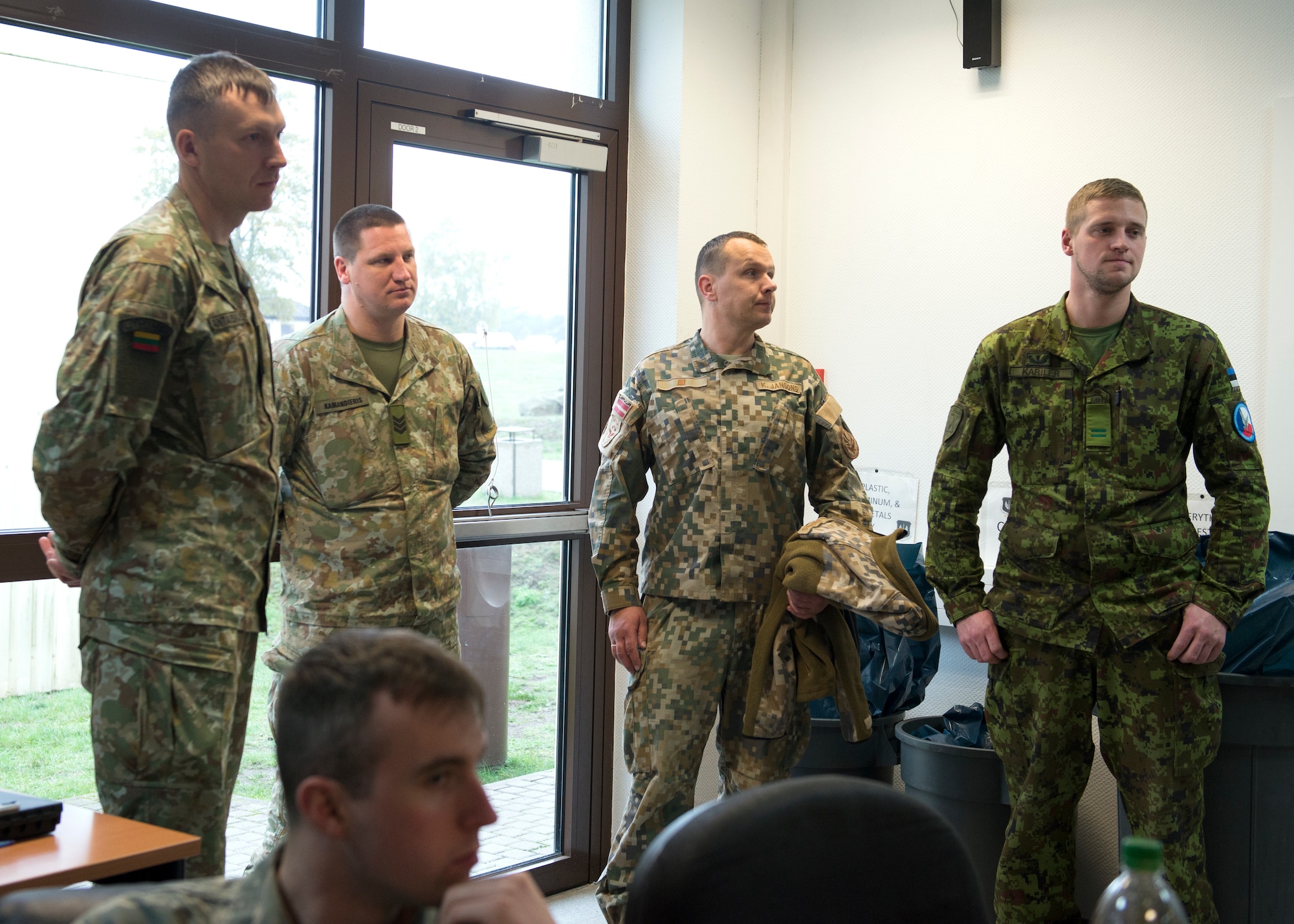 Members of Lithuania, Latvia and Estonia armed forces wait for further instructions at Ramstein Air Base, Germany, Nov. 6, 2019. Members of the 786th Civil Engineer Squadron partnered with NATO countries Lithuania and Estonia from Nov. 4-8, learning about each other’s processes for maintaining the aircraft arresting gear.