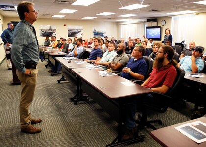 Mike Zydron (Code 200) talks to the attendees about the value of the work they do at NNSY.