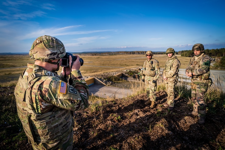 Pvt. 1st Class Stahlberg of 7th Army Training Command captures a photo of a U.S., French, and British Soldier at a tank live fire exercise during Dragoon Ready on Grafenwoehr Training Area.