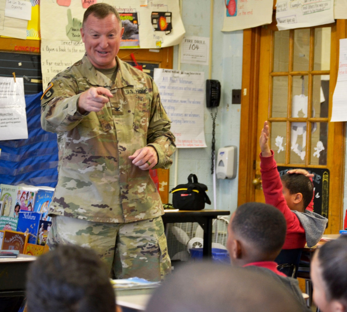 Army Col. Matthew Voyles, DLA Troop Support Medical supply chain director, talks with students during a Veterans Day event at the Gilbert Spruance Elementary School Nov. 7, 2019 in Philadelphia.