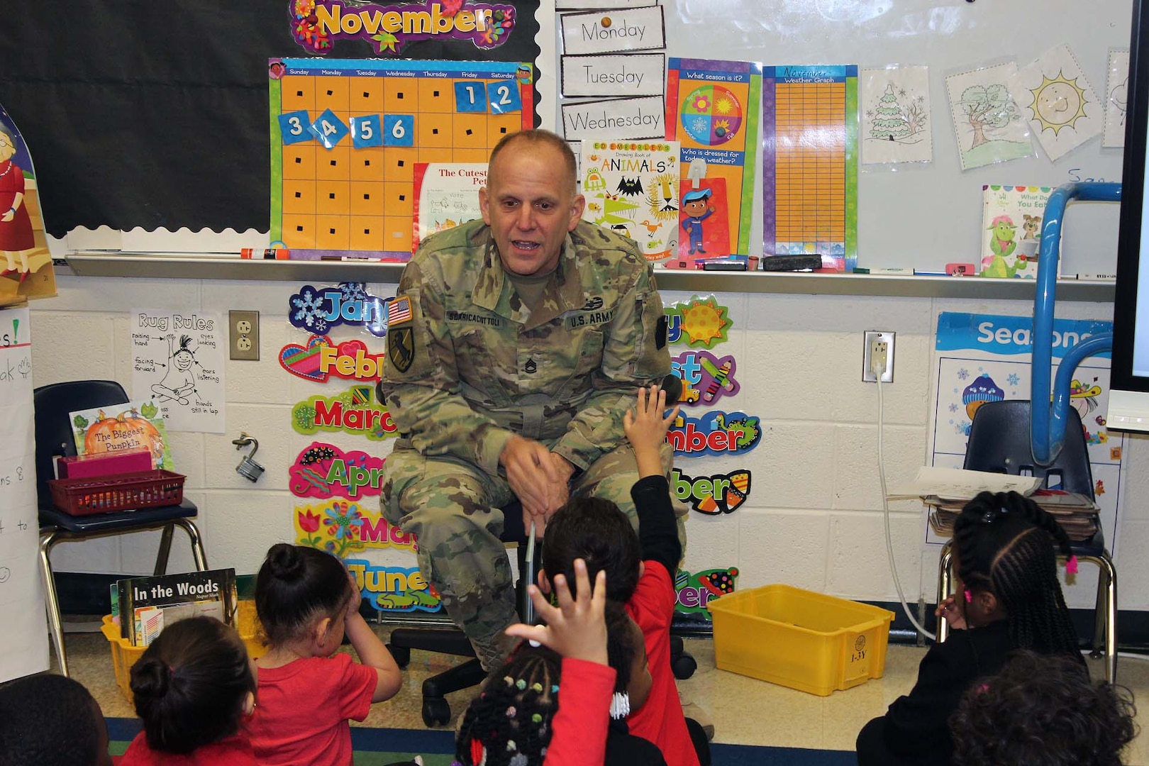 Army Sgt. 1st Class Richard Scaricaciottoli, a DLA Installation Philadelphia visual information specialist and Army reservist, speaks with students during a Veterans Day event at the Gilbert Spruance Elementary School Nov. 7, 2019 in Philadelphia.