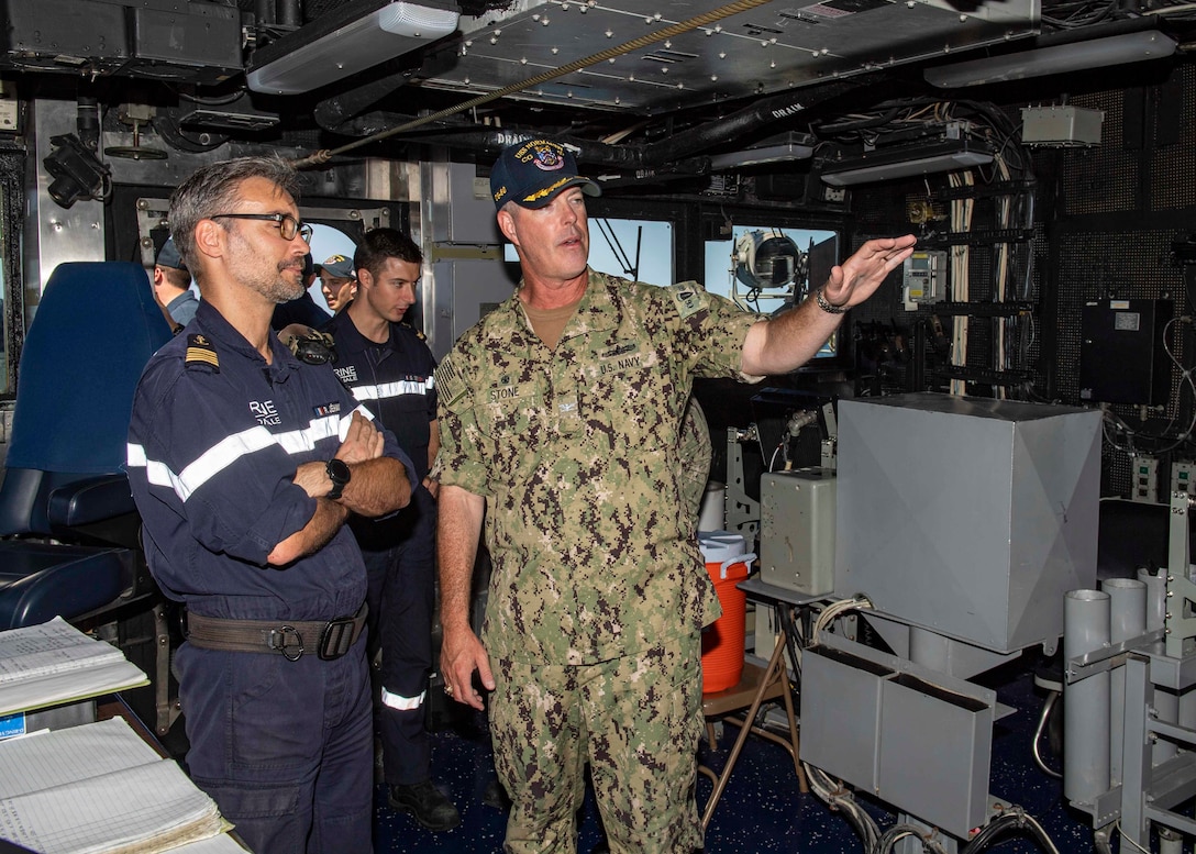 U.S. Navy Capt. Chris. D. Stone, the commanding officer of the guided-missile cruiser USS Normandy (CG 60), gives a tour of the ship's pilot house to the commanding officer of the French Navy ship Jean Bart during International Maritime Exercise 2019 (IMX 19). The exercise is a multinational engagement involving partners and allies from around the world designed to facilitate the sharing of knowledge and experiences across the full spectrum of defensive maritime operations. IMX 19 serves to demonstrate the global resolve in maintaining regional security and stability, freedom of navigation and the free flow of commerce from the Suez Canal south to the Bab el-Mandeb Strait through the Strait of Hormuz to the Northern Arabian Gulf. (U.S. Navy photo by Mass Communication Specialist 2nd Class Michael H. Lehman)