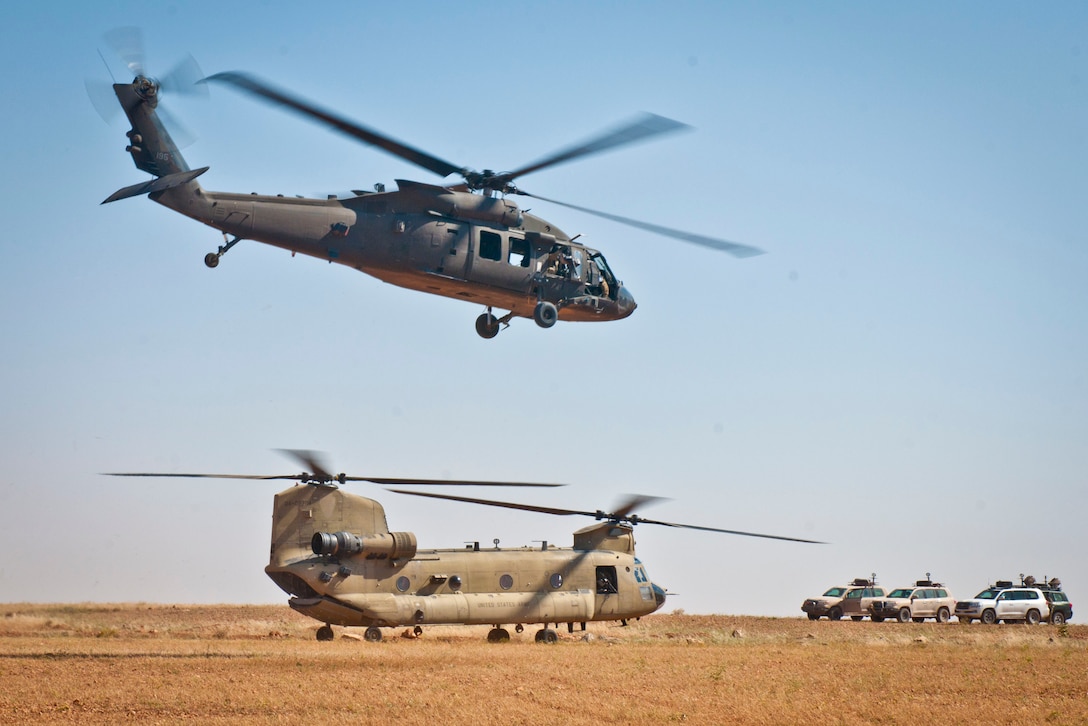 A UH-60 Blackhawk takes off from a nearby outpost following a key leader engagement near Manbij, Syria, June 21, 2018. Several high-ranking Coalition and U.S. Government officials spent the day discussing current military operations and touring the city of Manbij to witness how safe and prosperous it has become since being liberated from ISIS by the Syrian Democratic Forces. (U.S. Army photo by Staff Sgt. Timothy R. Koster)