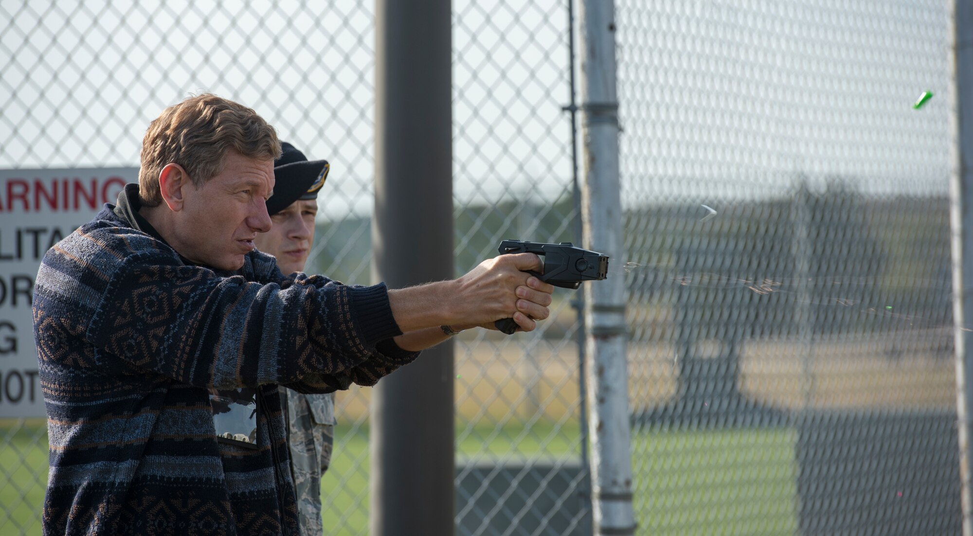 Dave Heller, a participant of the Joint Civilian Orientation Conference, uses a Taser gun at Joint Base Langley-Eustis, Virginia, Nov. 7, 2019.