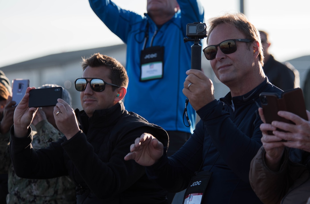 Joint Civilian Orientation Conference delegates watch aerial maneuvers during an F-22 Demonstration team practice as part of the Joint Civilian Orientation Conference on Joint Base Langley-Eustis, Virginia, Nov. 7, 2019.