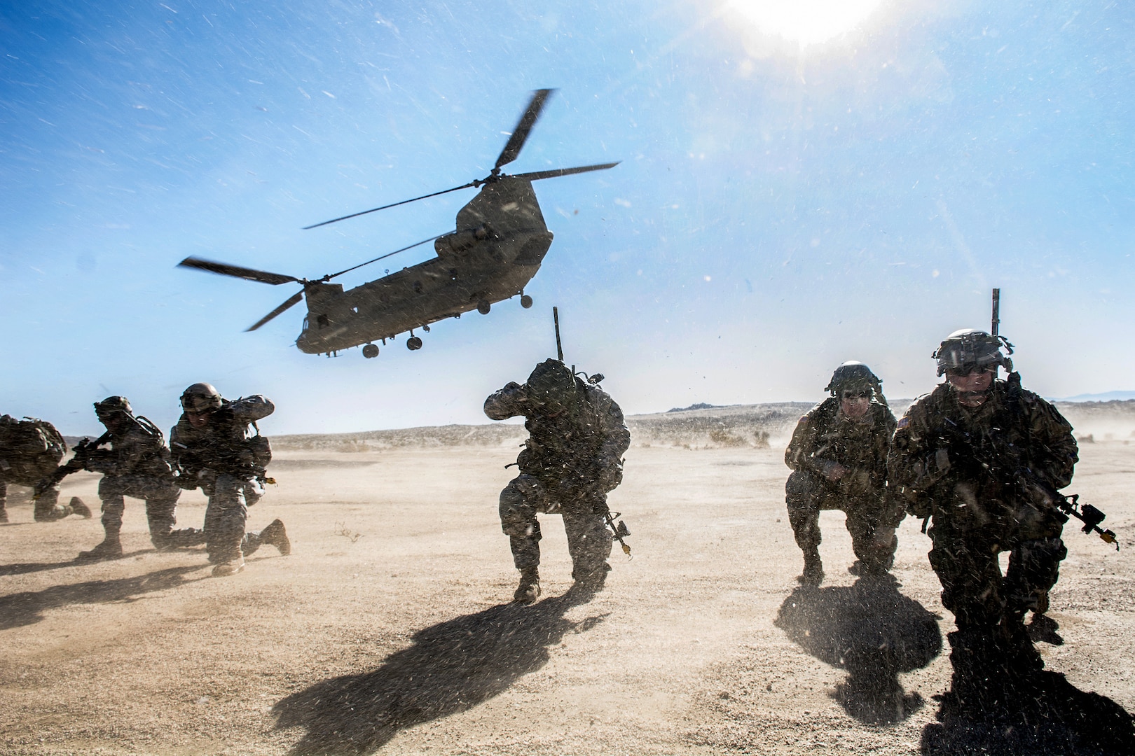 Soldiers maintain security as a CH-47 Chinook departs the HLZ during an air assault training exercise in the National Training Center, California, Jan. 25, 2017. The purpose of this mission was to demonstrate the troop's ability to carry out complex attacks while enhancing the unit's ability of employing aviation resources.