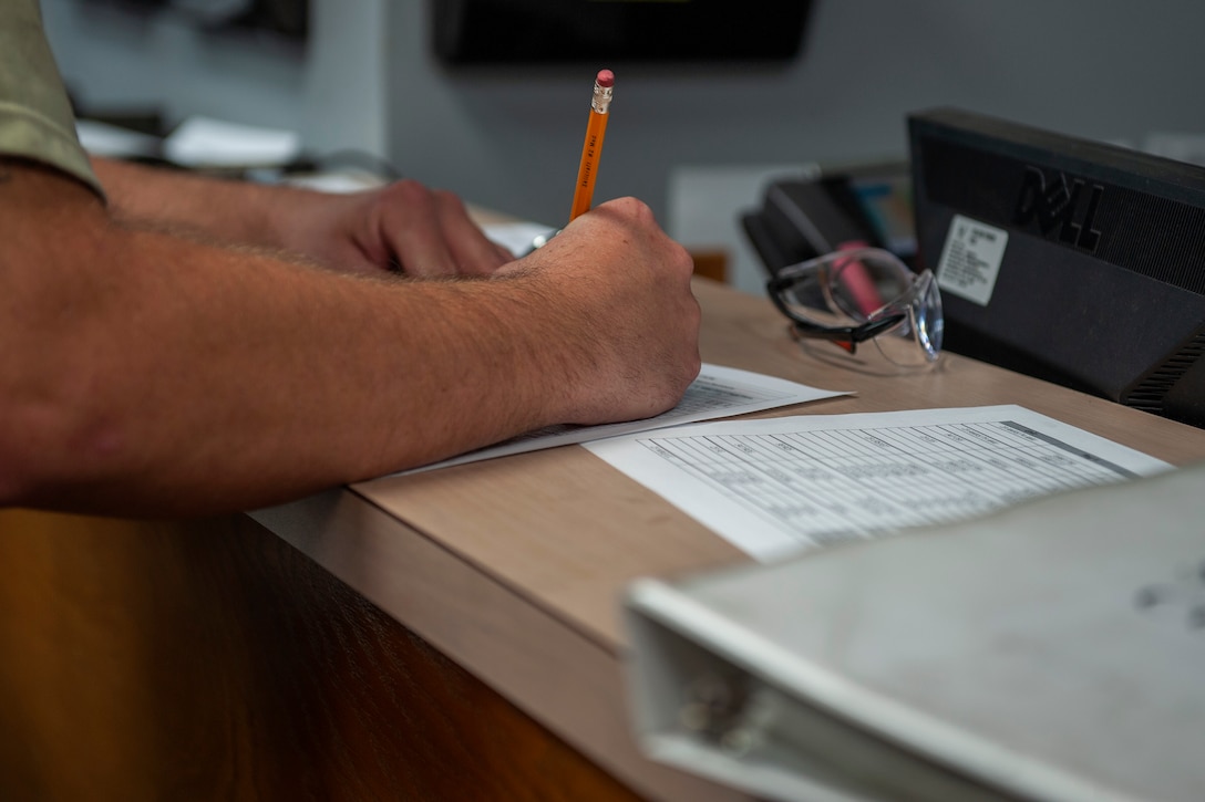 An Airman assigned to the 23d Logistics Readiness Squadron (LRS) fills out a work order Nov. 4, 2019, at Moody Air Force Base, Ga. The 23d LRS vehicle management section is responsible for the maintenance and upkeep of 432 of Moody’s government-owned vehicles. (U.S. Air Force photo by Airman 1st Class Jasmine M. Barnes)