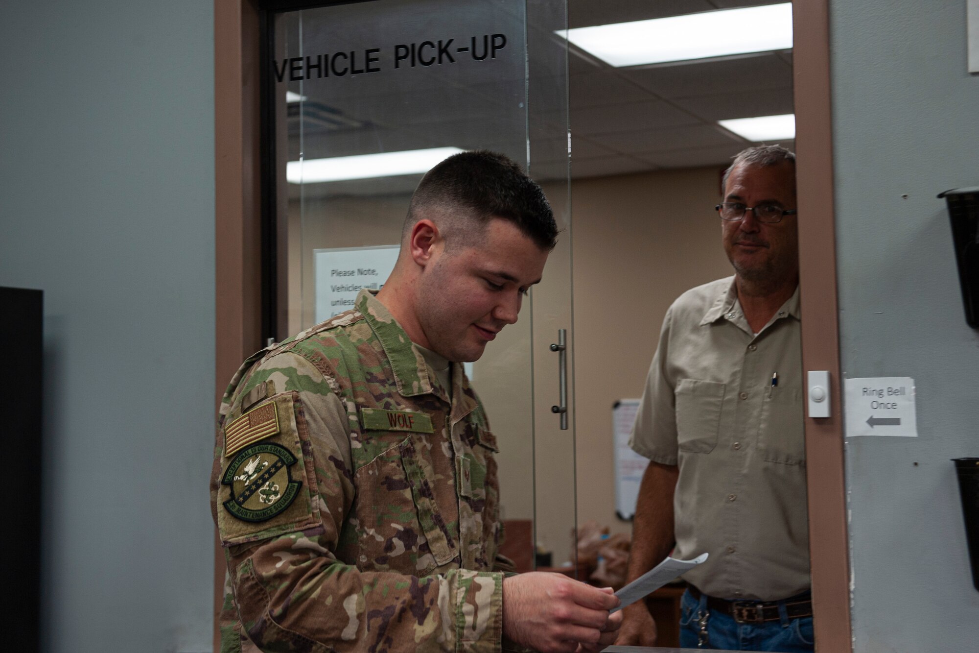 A photo of a customer receiving vehicle pick-up paperwork