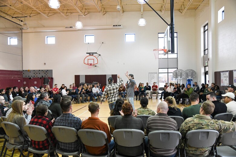 Facilitator Kevin Synarski congratulates a volunteer on “getting weird” and building morale in a team-building activity during a Challenge Day event Nov. 4, 2019 at Peterson Air Force Base, Colorado. Challenge Day helps people learn to recognize internal and external social and emotional issues and pressures. (U.S. Air Force Photo by Erica Blanton)