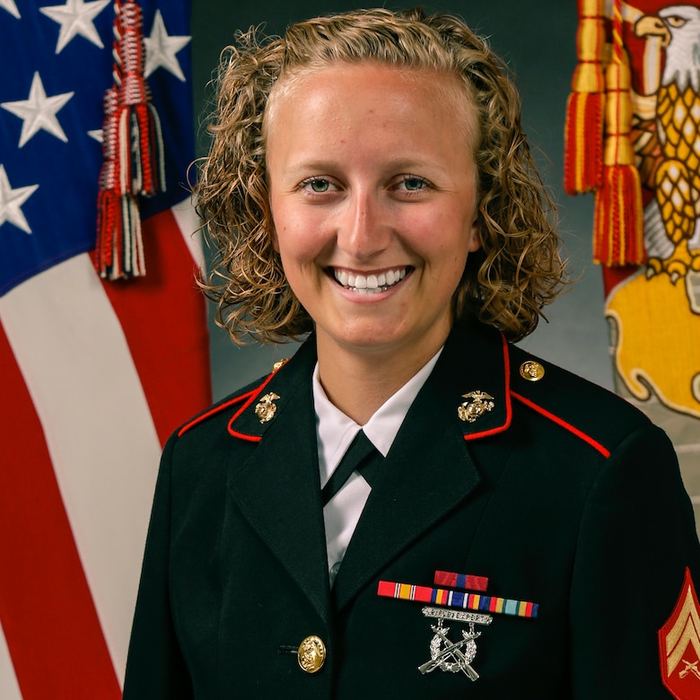 A Marine poses for a picture in dress uniform.