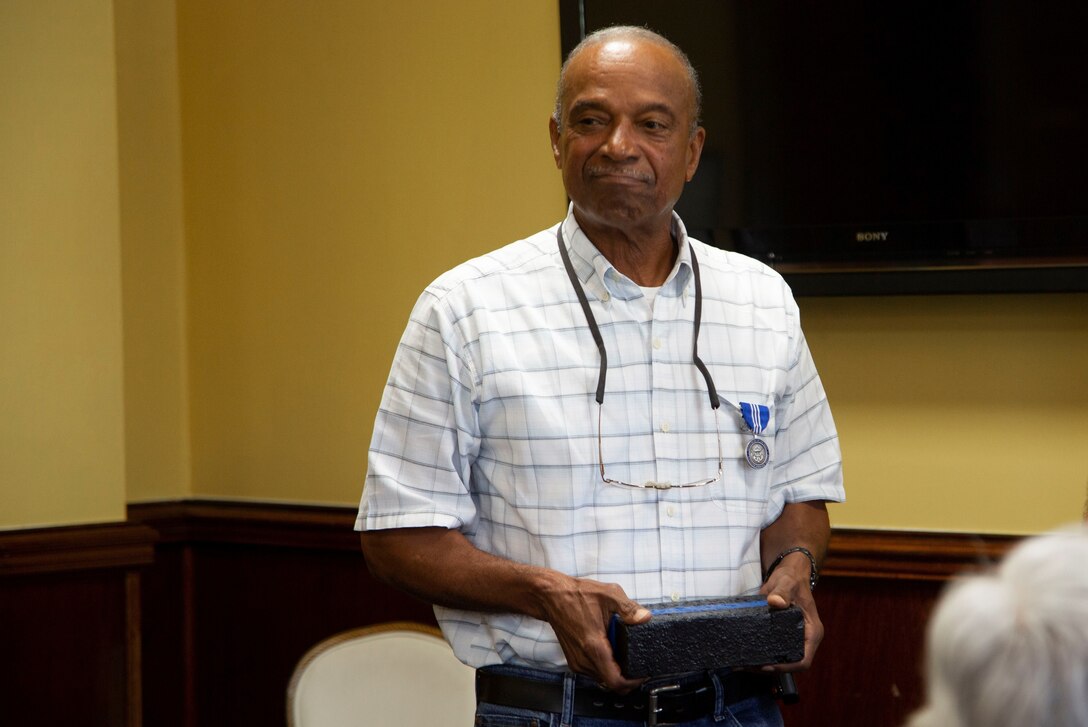 Earnest B. Freeman receives a brick from building four during his retirement luncheon at the Paradise Point Officers Club on Marine Corps Base Camp Lejeune, Oct. 30, 2019. Freeman retired as the evidence custodian, Criminal Investigation Division, Provost Marshals Office, Marine Corps Installations East-MCB Camp Lejeune, with 45 years of combined active duty Marine Corps service and civilian service.