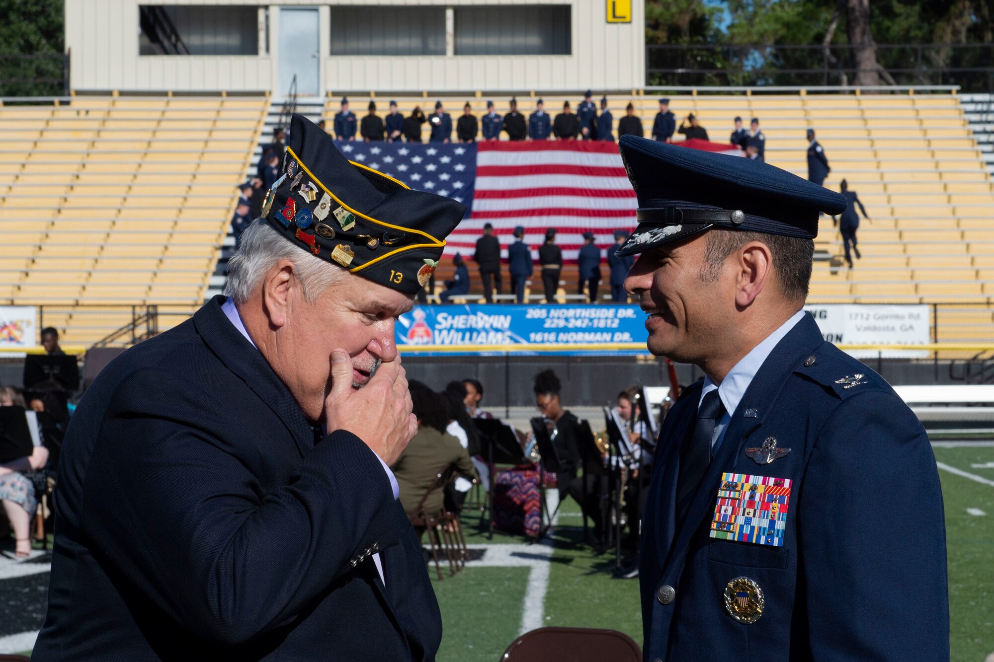 A photo of 23d Wing Vice Commander speaking with the master of ceremonies at a Veterans Day Observance