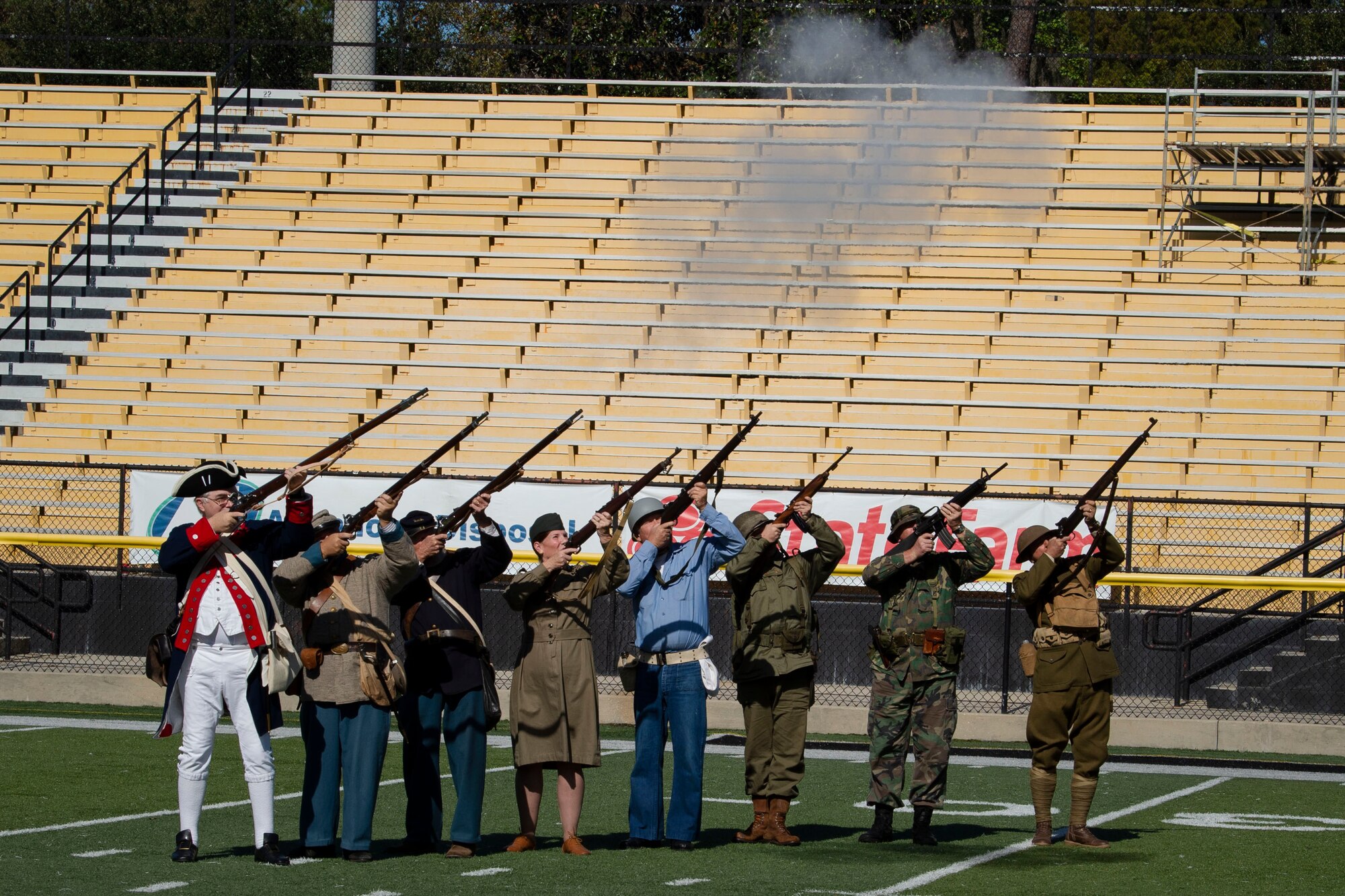A photo of volunteers conducting a 21-gun salute during a Veterans Day Observance