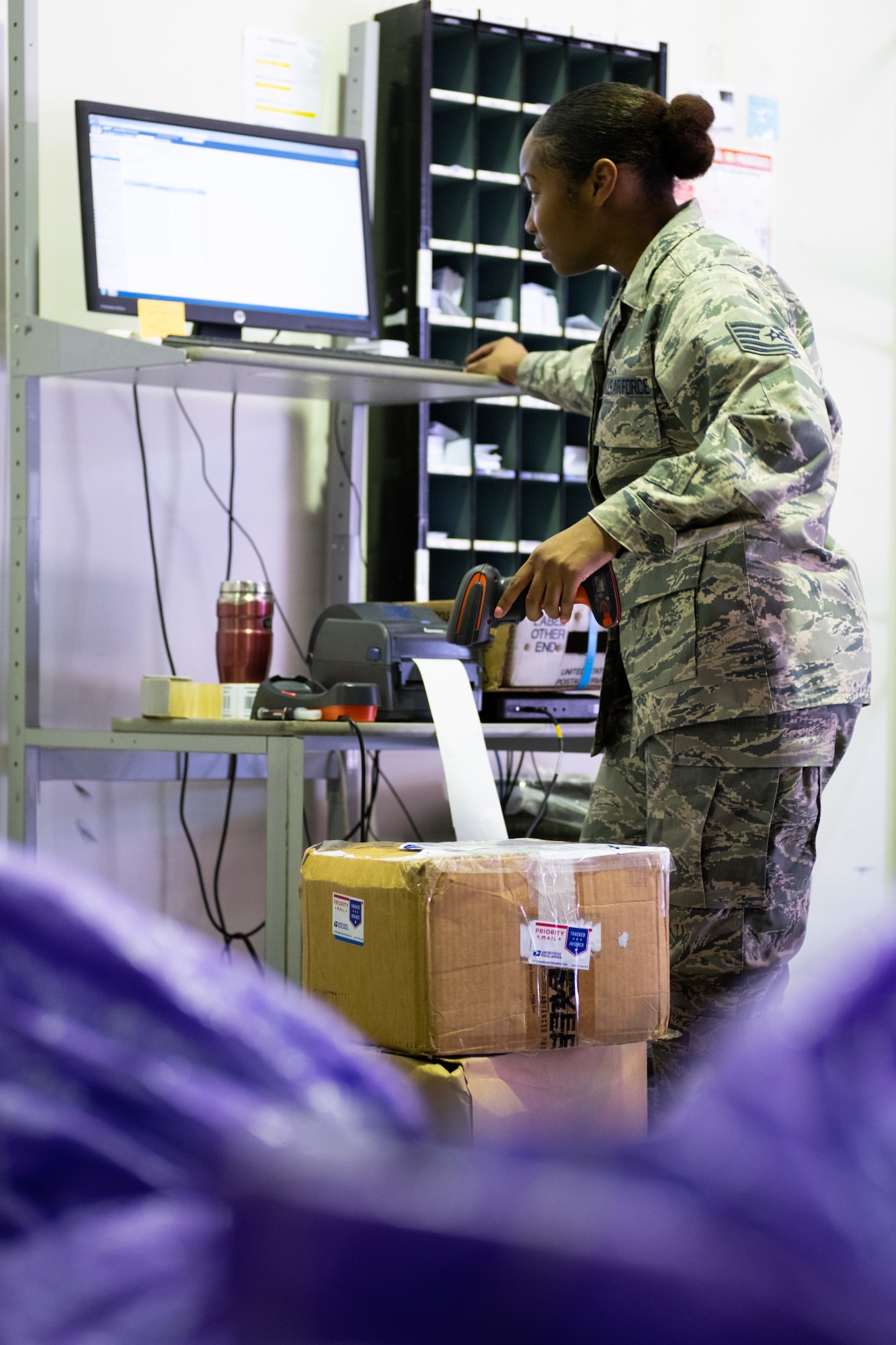 Tech. Sgt. Faneshia Walton, Pacific Air Forces Air Postal Squadron Det 4 aerial mail terminal chief, processes outgoing mail at the mail warehouse in Sydney, August 24, 2019. The detachment supports all military personnel, DoD employees and their families assigned to Australia. (U.S. Air Force photo by Master Sgt. Benjamin Wilson)
