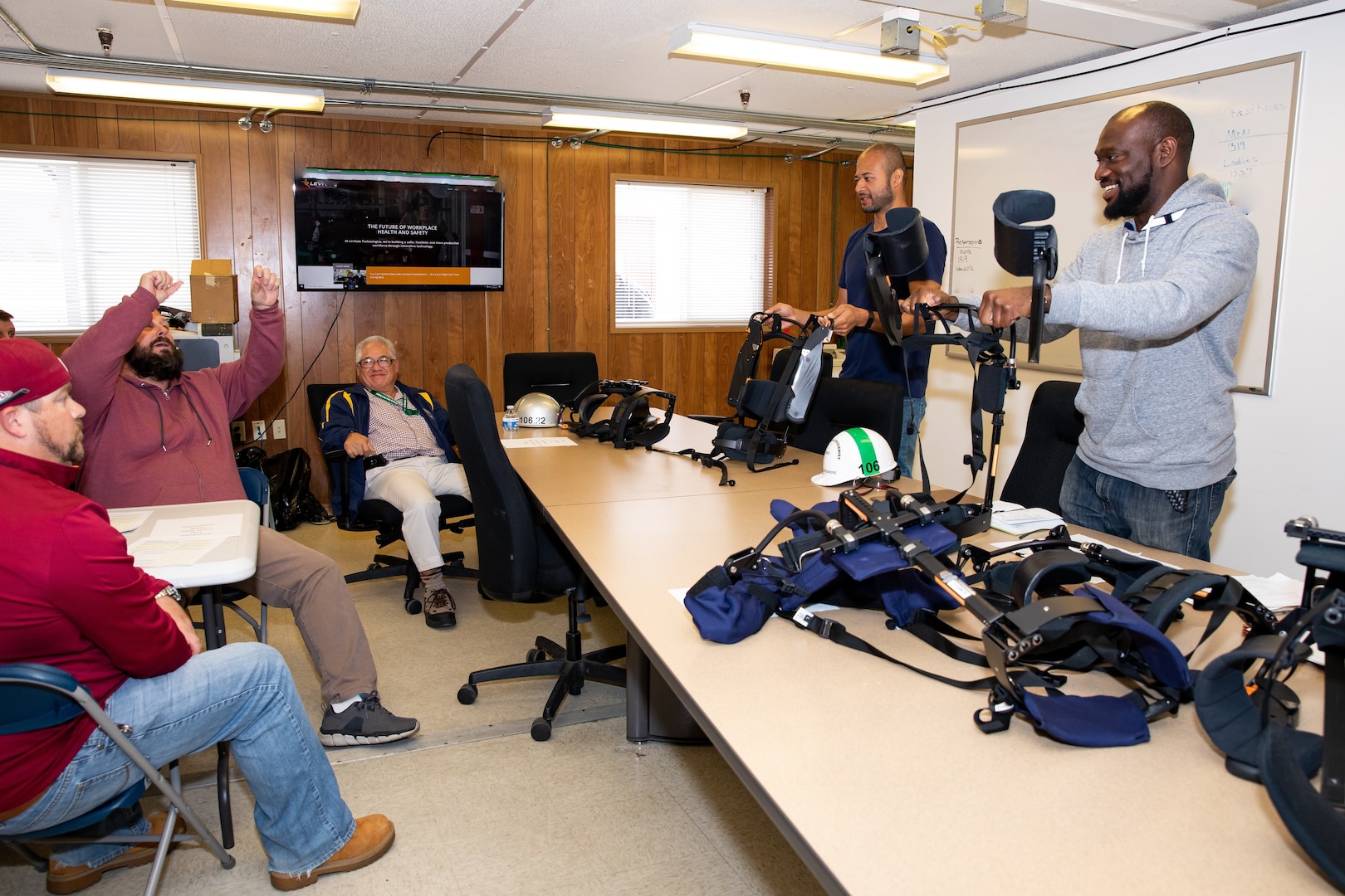 Robotics Subcommittee Lead Edwin Guerra and Ergonomics Program Manager James Musgrove lead the demonstration of the Levitate Airframe exoskeleton suit during the Temporary Facilities and Tool Control (Code 900F) Safety Committee meeting.