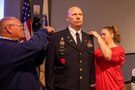 U.S. Army Col. Christopher Caldwell has his new rank pinned on by his wife and father during his promotion ceremony at Joint Task Force Civil Support (JTF-CS) headquarters. The ceremony was presided over by JTF-CS Commanding General U.S. Army Maj. Gen. William “Bill” Hall, and was attended by Caldwell’s family, friends and fellow JTF-CS staff. (Official DoD photo by Mass Communication Specialist 3rd Class Michael Redd/RELEASED)