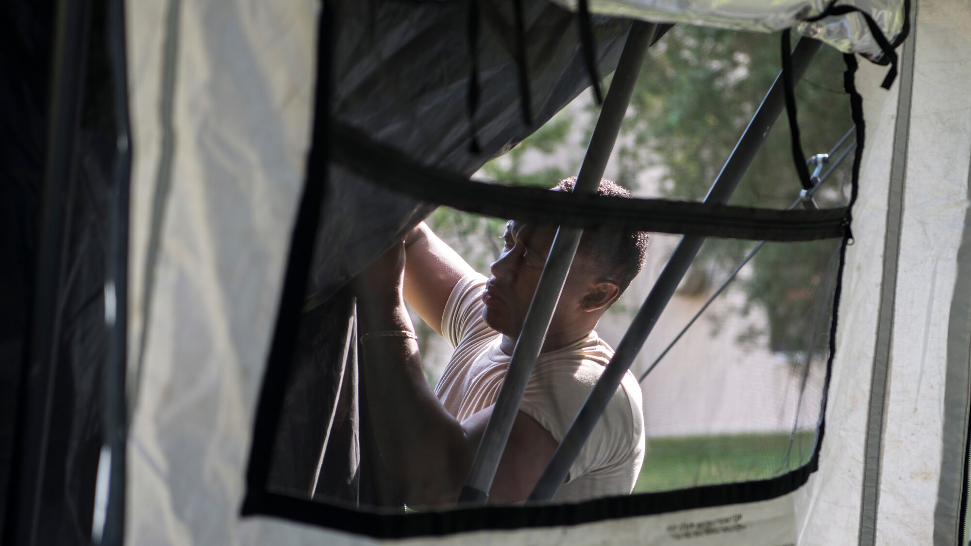 U.S. Air Force Airman 1st Class Chris Christie, a 6th Contracting Squadron (CONS) contract specialist, constructs a tent at MacDill Air Force Base, Fla., Nov. 5, 2019.