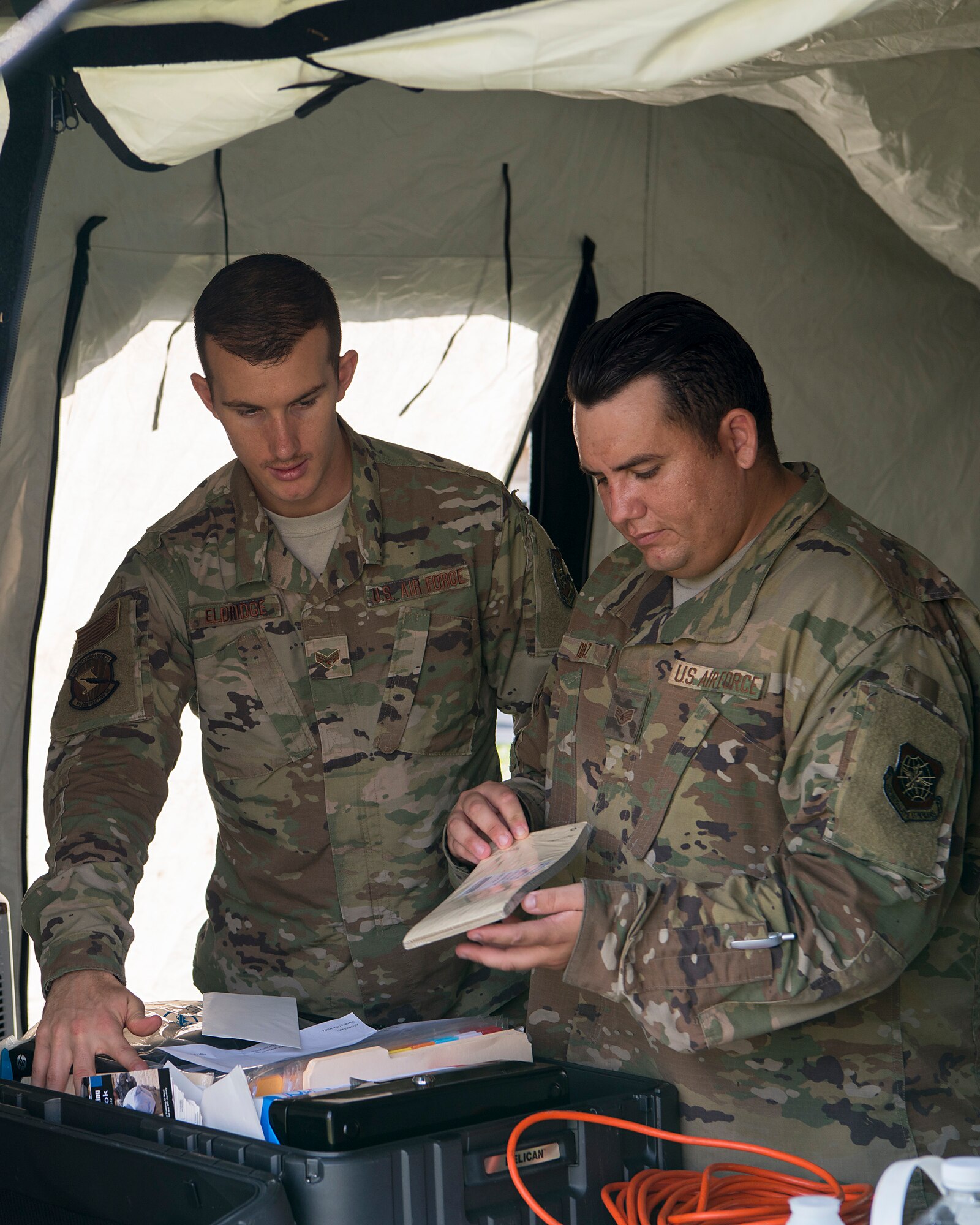 U.S. Air Force Senior Airman William Eldridge and Staff Sgt. Kalen Diaz, 6th Contracting Squadron contract specialists, unload a deployment kit at MacDill Air Force Base, Fla., Nov. 5, 2019.