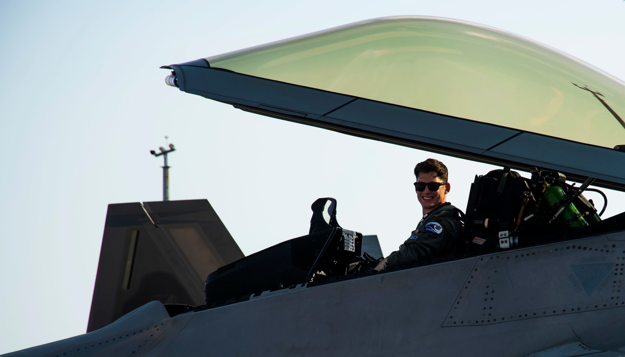 The pilot of an F-22 Raptor poses for a photo Nov. 6, 2019, at Tyndall Air Force Base, Florida. The pilot, airframe, and maintenance team supported Checkered Flag 20-1, which is a large-scale aerial exercise designed to integrate fourth and fifth-generation airframes to enhance mobility, deployment, and employment capabilities of aviators and maintainers. The exercise involved airpower assets, more than 50 aircraft, and support personnel from multiple installations. Aircraft and pilots participated in a Weapons System Evaluation Program and are evaluated on air-to-air and air-to-ground operations, providing a unique training environment. (U.S. Air Force photo by Staff Sgt. Magen M. Reeves)