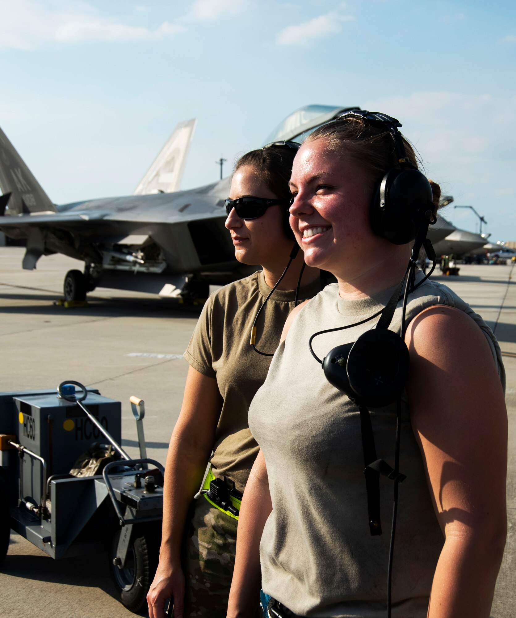 Two Airmen support aircraft operations on the flight line Nov. 6, 2019, at Tyndall Air Force Base, Florida. Tyndall supported Checkered Flag 20-1, which is a large-scale aerial exercise designed to integrate fourth and fifth-generation airframes to enhance mobility, deployment, and employment capabilities of aviators and maintainers. The exercise involved airpower assets, more than 50 aircraft, and support personnel from multiple installations. Aircraft and pilots participated in a Weapons System Evaluation Program and are evaluated on air-to-air and air-to-ground operations, providing a unique training environment. (U.S. Air Force photo by Staff Sgt. Magen M. Reeves)