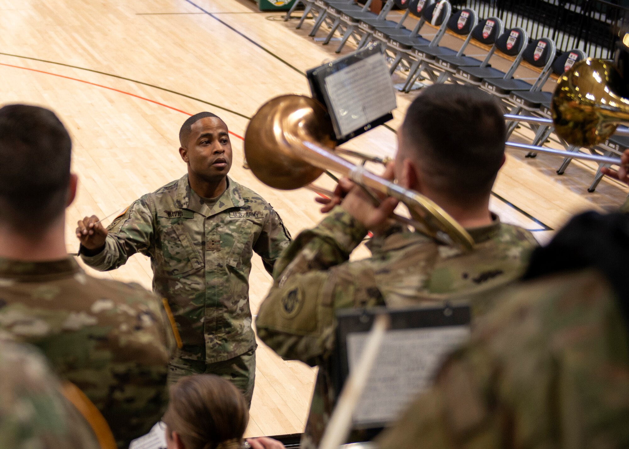 Chief Warrant Officer 2 Alexander Davis, 9th Army Band commander conductor, conducts before the ninth annual Armed Forces Classic at the Alaska Airlines Center in Anchorage, Alaska, Nov. 8, 2019. ESPN hosted the event in partnership with Joint Base Elmendorf-Richardson, Alaska. Every year, the Armed Forces Classic travels to a new military location around the world. The Marine Corps will host the 2020 Armed Forces Classic at Camp Lejeune, North Caro