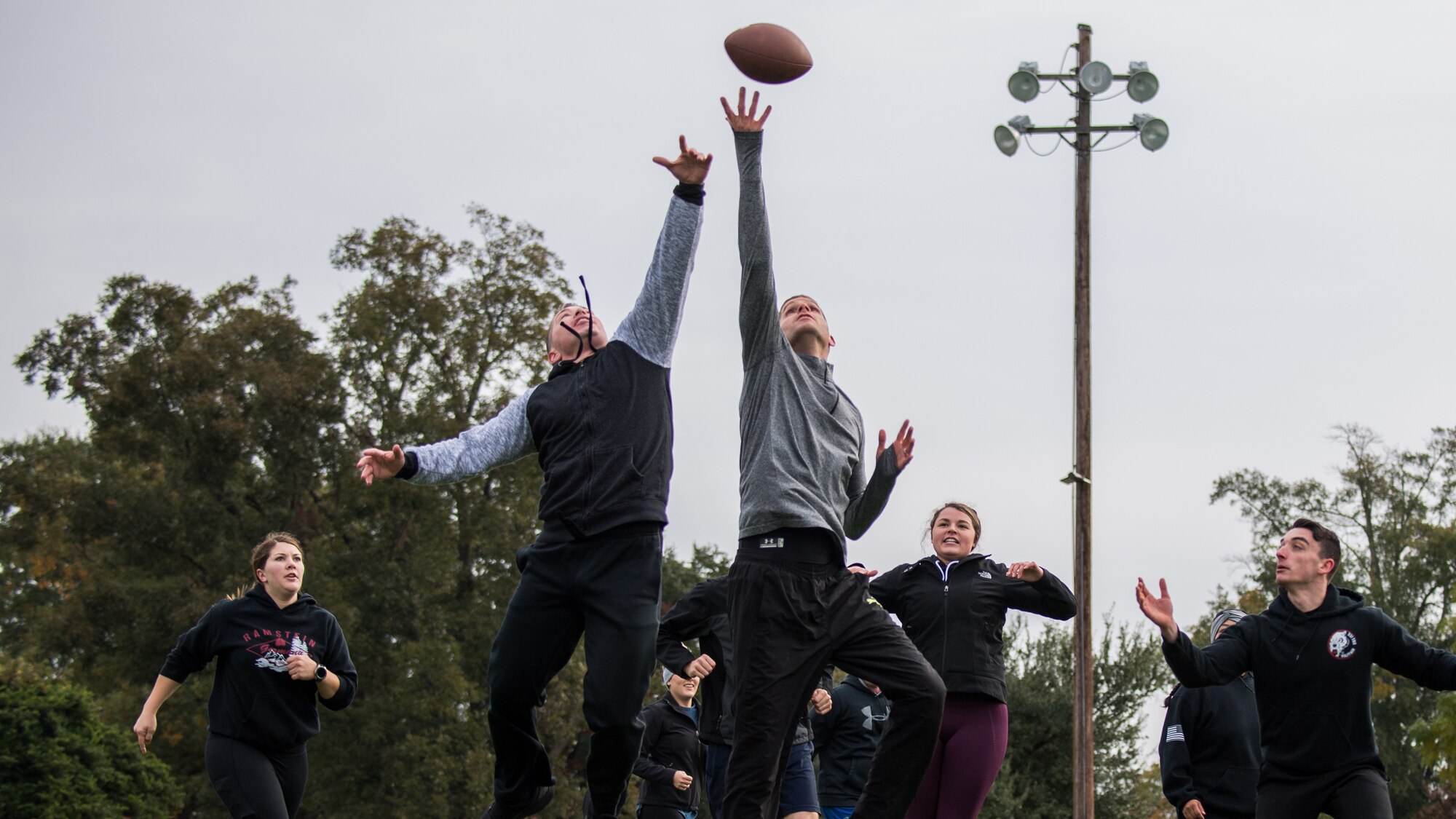 Airmen from the 608th Air Operations Center play football during their unit's resiliency sports day at Barksdale Air Force Base, La., Nov. 8, 2019.