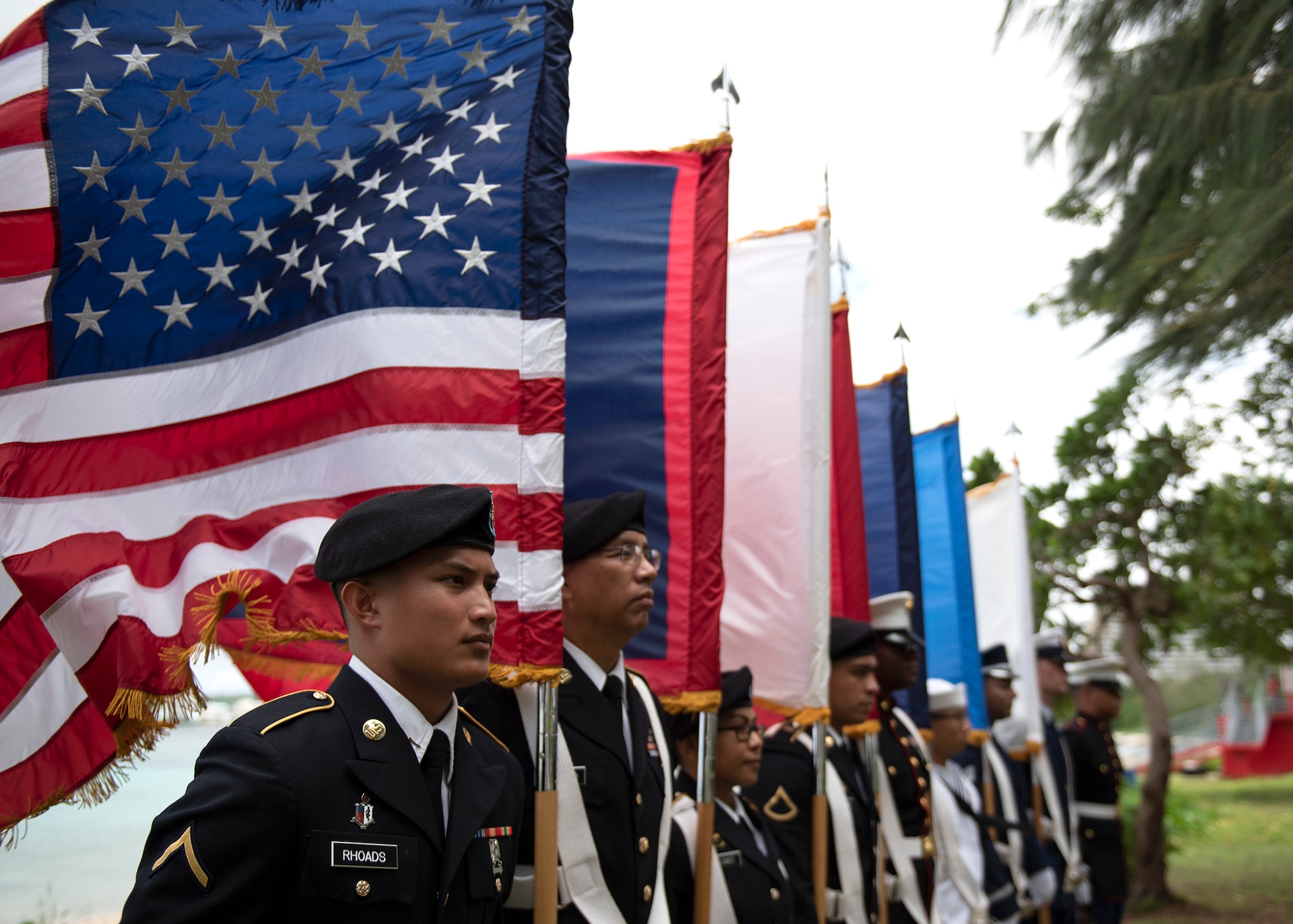 Members of the U.S. Joint Color Guard stand in formation prior to the start of the Veterans Day Ceremony Nov. 11, 2019 at Ypao Beach, Guam. The Veterans Day ceremony celebrated the service of all U.S. military veterans and coincides with Armistice Day and Remembrance Day which are celebrated in other countries, marking the anniversary of the end of World War I.