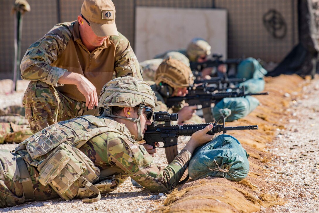 Soldiers fire weapons form the ground toward targets.