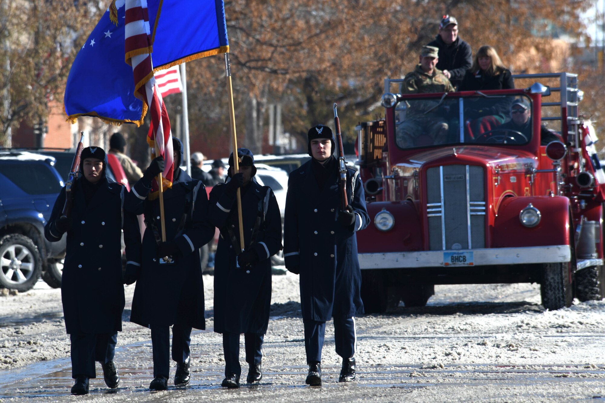 The Ellsworth Air Force Base, S.D., Honor Guard walks in the 2019 Veteran’s Day Parade ahead of the flagship fire truck on Main Street in Rapid City, S.D., Nov. 11, 2019. Col. David A. Doss, 28th Bomb Wing commander, and his spouse, Marlina, rode in the truck and waved to those in attendance. (U.S. Air Force photo by Staff Sgt. Hailey Staker)