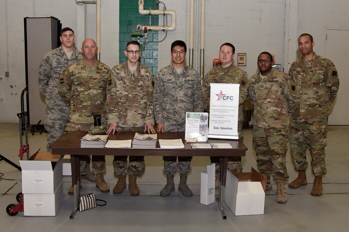 A photo of Combined Federal Campaign group representatives posing for a picture at a CFC booth
