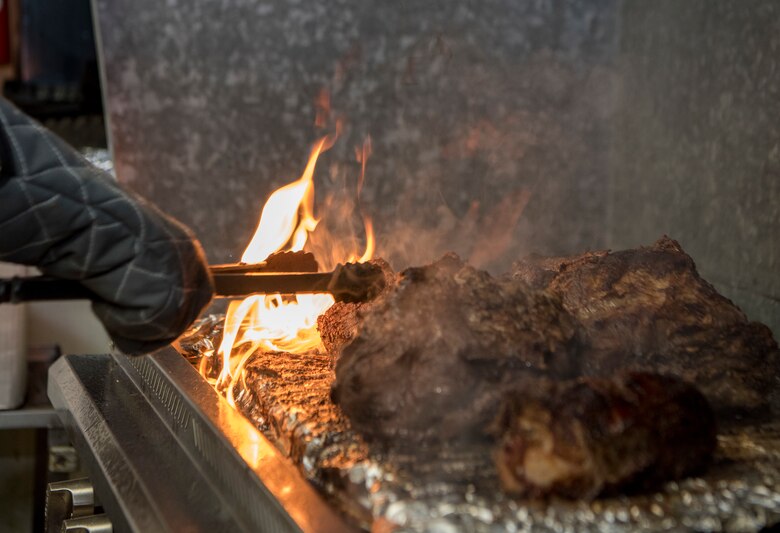U.S. Army 1st Sgt. Misty Boria, 626th Quartermaster Field Feeding Company, grills meat at the Eagle River VFW, Alaska, Nov. 9, 2019. The purpose of the event was to honor those who served in the military. Soldiers from the 9th Army Band and culinary specialist from the 626th Quartermaster Field Feeding Company volunteered to support the ceremony. Soldiers from the 626th Quartermaster have volunteered more than 100 hours to the Eagle River VFW.