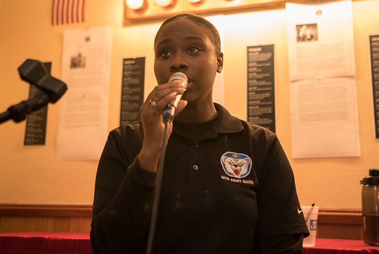 U.S. Army Sgt. Ashia Hunter, 9th Army Band vocalist, sings at the Eagle River VFW, Alaska, Nov. 9, 2019. The purpose of the event was to honor those who served in the military. Soldiers from the 9th Army Band and culinary specialist from the 626th Quartermaster Field Feeding Company volunteered to support the ceremony. Soldiers from the 626th Quartermaster have volunteered more than 100 hours to the Eagle River VFW.