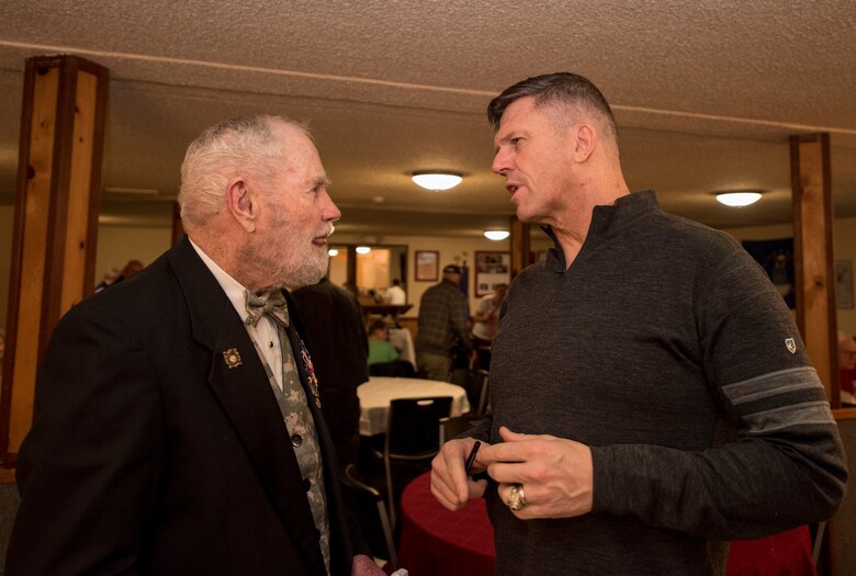 From right, U.S. Army Maj. Gen. Peter Andrysiak, U.S. Army Alaska commander, talks with a veteran at the Eagle River VFW, Alaska, Nov. 9, 2019. The purpose of the event was to honor those who served in the military. Soldiers from the 9th Army Band and culinary specialist from the 626th Quartermaster Field Feeding Company volunteered to support the ceremony. Soldiers from the 626th Quartermaster have volunteered more than 100 hours to the Eagle River VFW.
