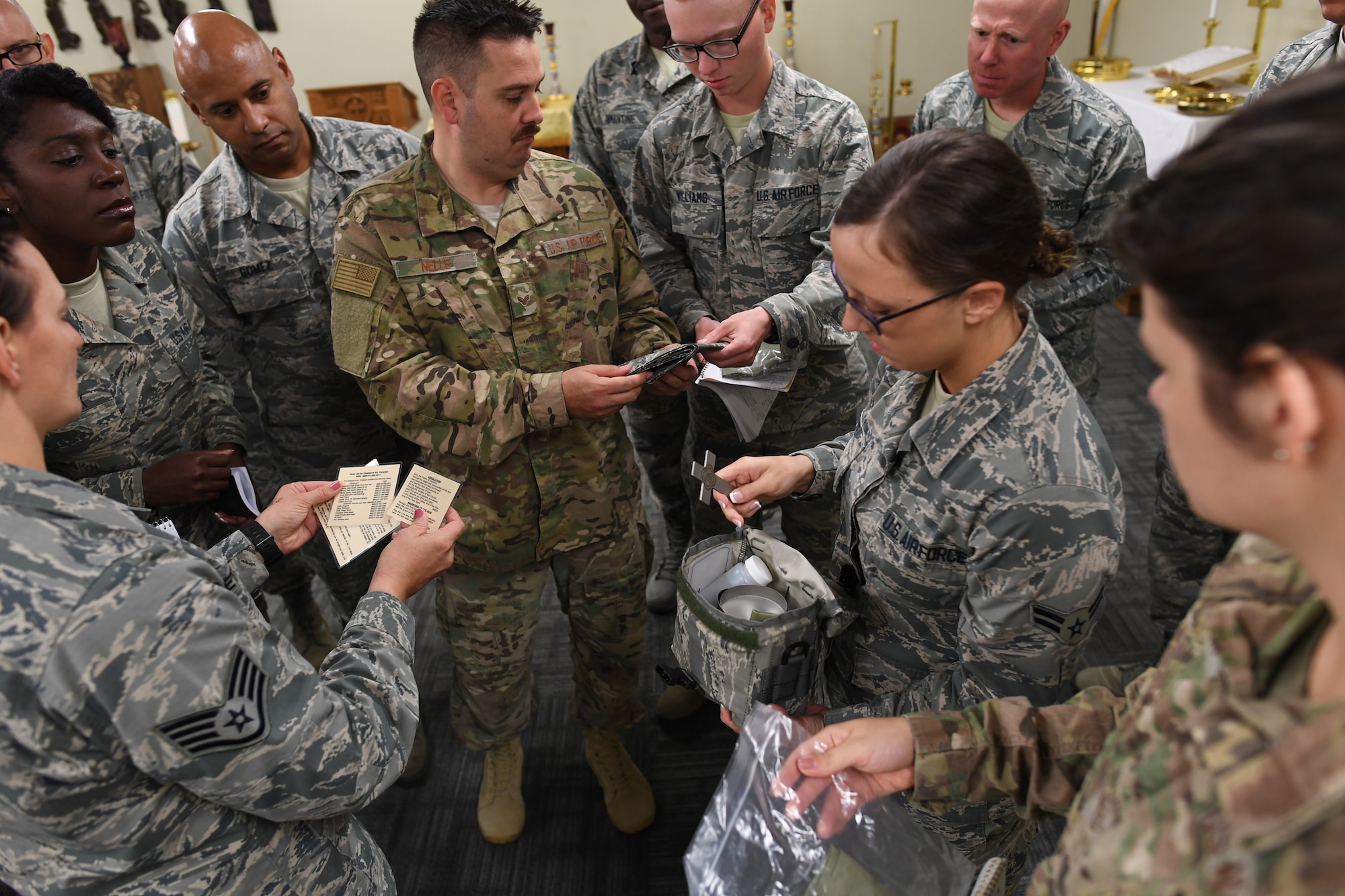 Airmen in the 335th Training Squadron religious affairs course view items in a chaplain's deployment kit inside Allee Hall at Keesler Air Force Base, Mississippi, Oct. 17, 2019. The six-week-long technical training course has been relocated and revamped to improve the training of their enlisted Airmen. (U.S. Air Force photo by Kemberly Groue)